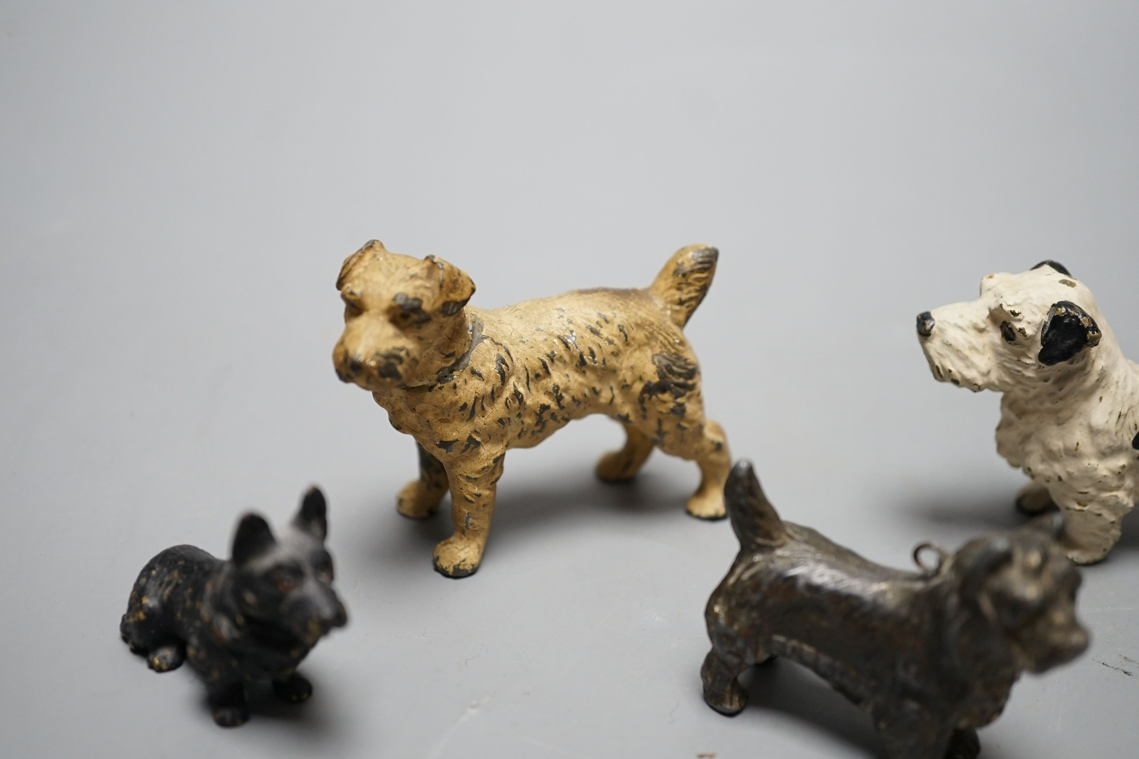 Four cold painted dogs, two bronze, tallest 5.5cm